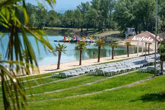 Palm trees and loungers on the lakeshore